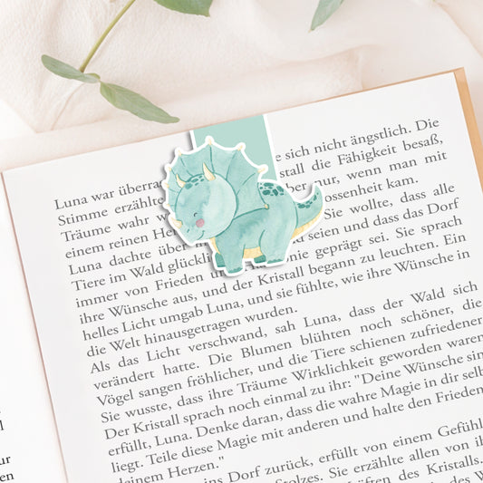 Magnetisches Lesezeichen Dino mit handgemaltem Dinosaurier-Motiv, auf hochwertigem Papier gedruckt und mit Vinyl versiegelt, ideal als Geschenk für Buchliebhaber.