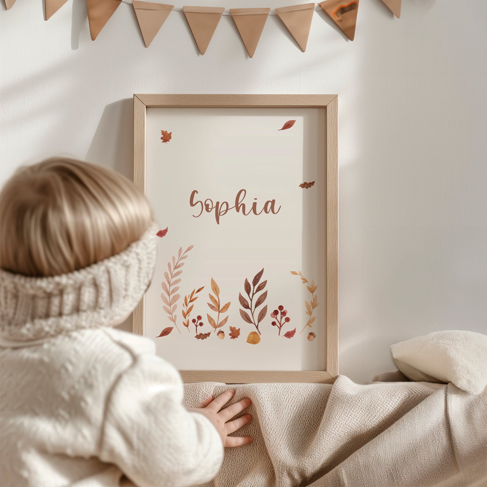 Ein Kind betrachtet das personalisierte Namensposter Sophia, Teil des 3er Sets Waldtiere, ideal für Kinderzimmerdekoration, auf einem beige Untergrund liegend.