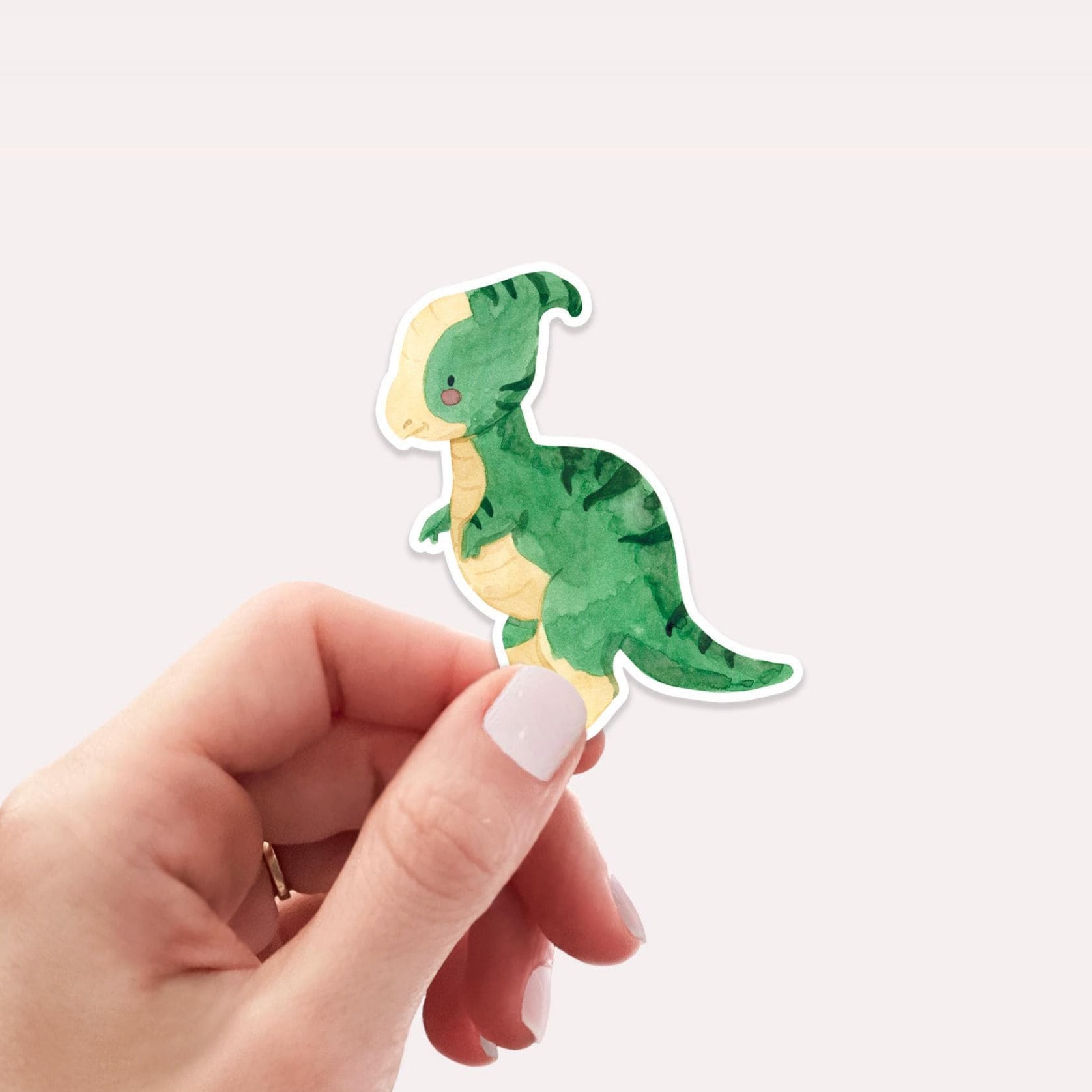 Hand hält Sticker Dinosaurier Parasauro, handgefertigt aus hochwertigem Vinyl, ideal zum Dekorieren von Bullet Journals, Schulheften, Laptops oder Handyhüllen.