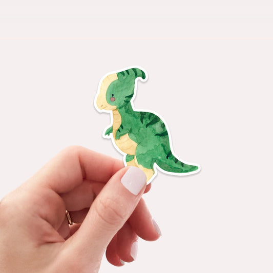 Hand hält Sticker Dinosaurier Parasauro, handgefertigt aus hochwertigem Vinyl, ideal zum Dekorieren von Bullet Journals, Schulheften, Laptops oder Handyhüllen.