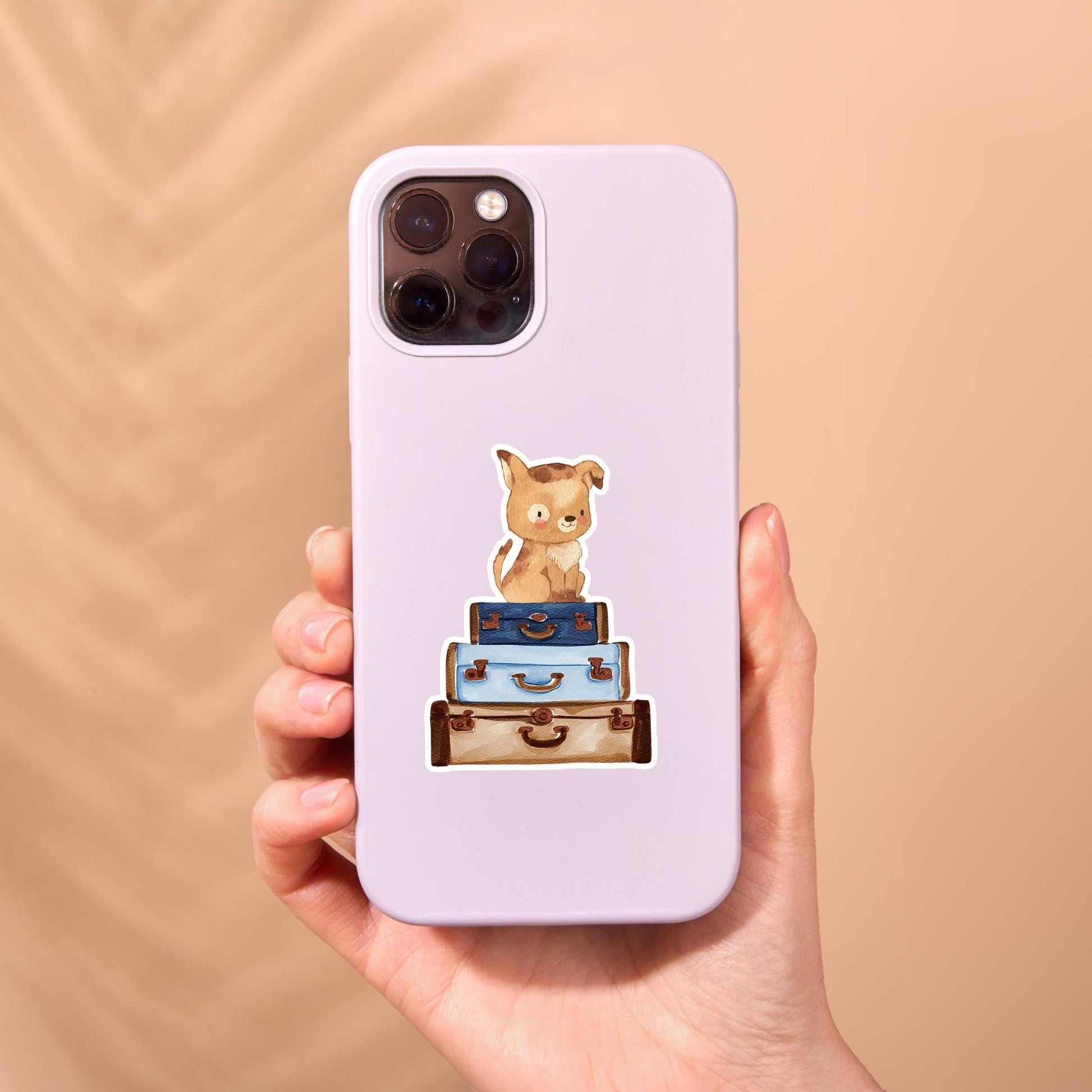 Sticker Hund & Koffer: Person hält Handyhülle mit handgemaltem Hunde-Sticker, ideal für Reisen. Langlebiger Vinyl-Sticker, perfekt für individuelle Gestaltung.