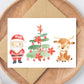 Weihnachtskarte Weihnachtsmann & Rentier A6 auf hochwertigem Naturpapier, Rentier und Weihnachtsbaum. Auf Holzplatte, ideal für Weihnachtsgrüße.