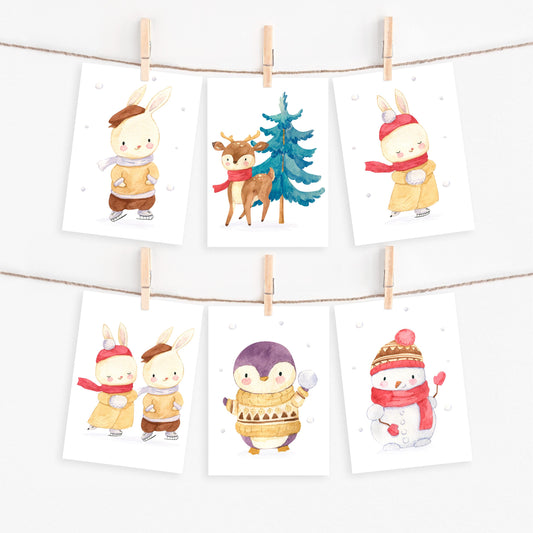 Weihnachtskarten-Set 6 Karten Winter A6, mit weihnachtlichen Aquarellillustrationen von Tieren und Schneemännern, an einer Leine mit Wäscheklammern aufgehängt.