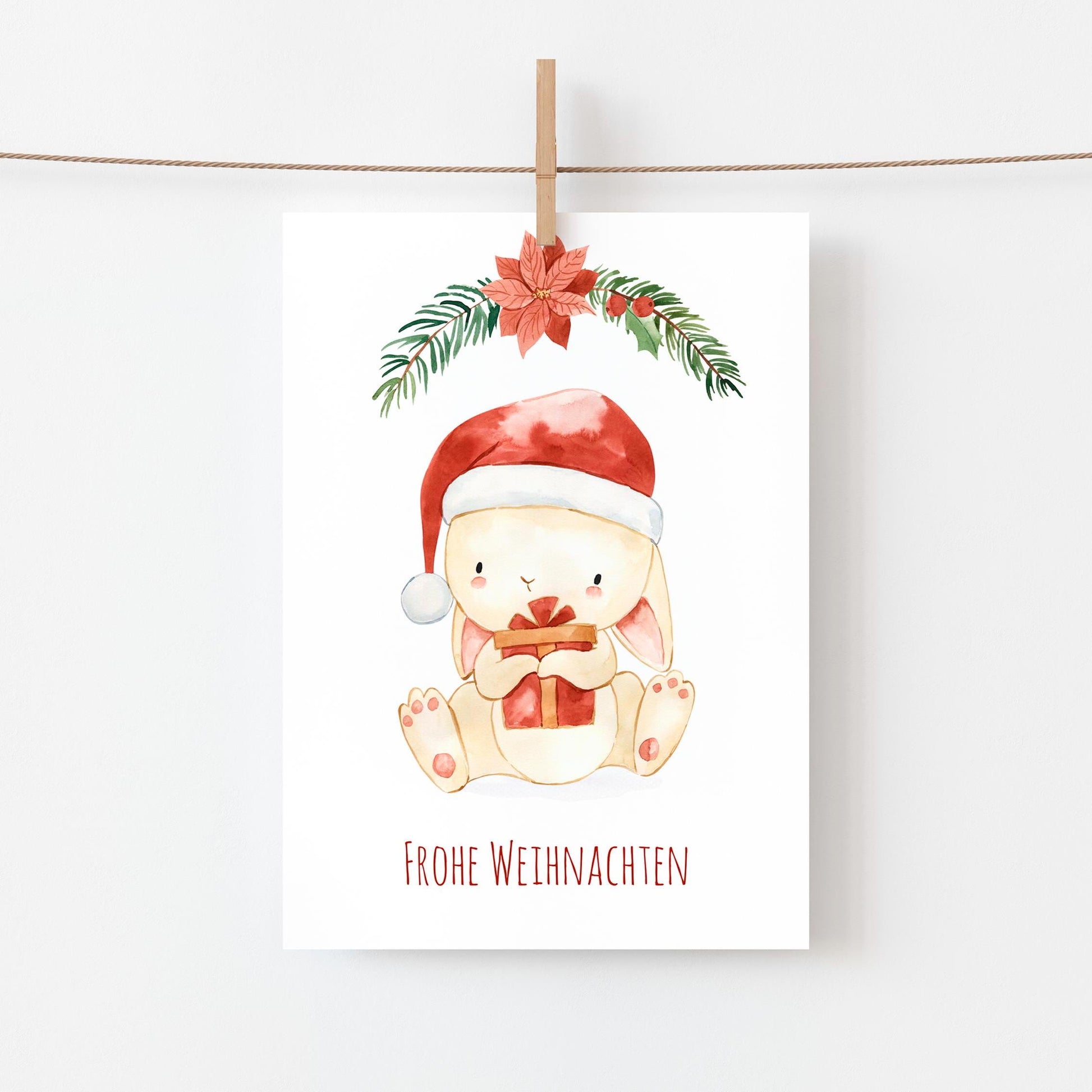 Weihnachtskarte Weihnachtshase, Text: Frohe Weihnachten, Aquarell-Illustration: Hase, der ein Geschenk hält, A6, ideal für Weihnachtsgrüße oder Deko.