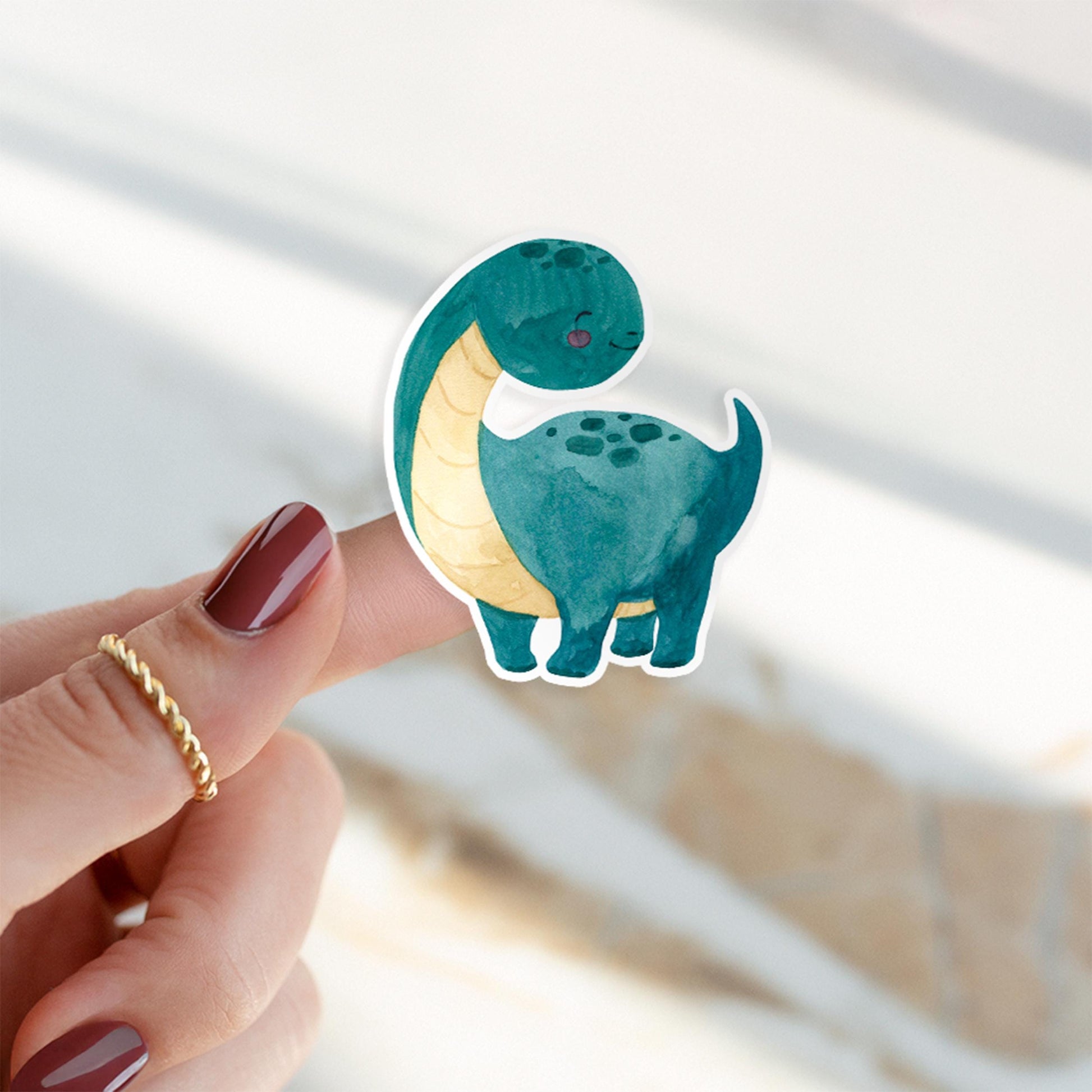 Sticker Dinosaurier dunkelgrün, handgemalter Vinyl-Aufkleber, von Person präsentiert, ideal für Bullet Journals oder Handyhüllen, langlebig und spritzfest, 6x5 cm groß.