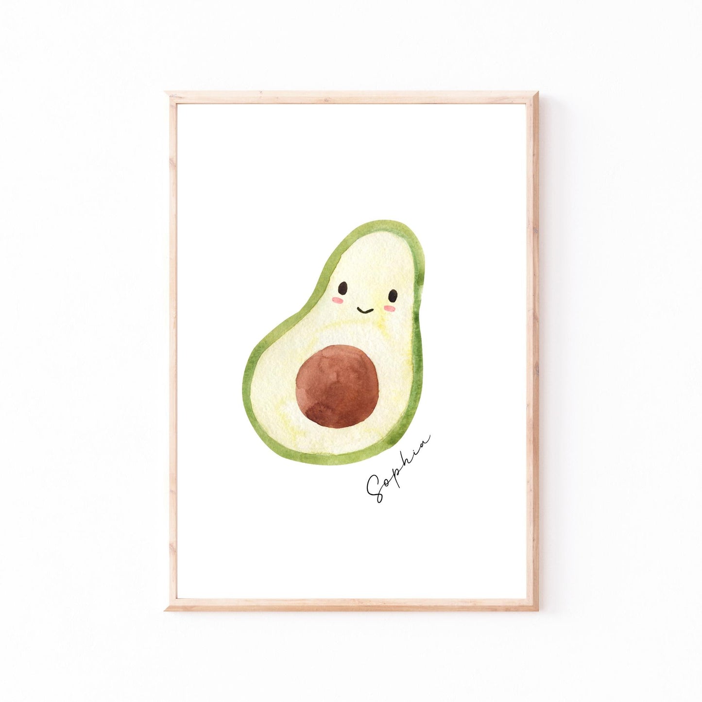 Namensposter Avocado A3 & A4: Framed watercolor illustration of a halved avocado with a kawaii face, signed Sophia, perfect for personalized children's room decor.