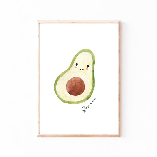 Namensposter Avocado A3 & A4: Framed watercolor illustration of a halved avocado with a kawaii face, signed Sophia, perfect for personalized children's room decor.