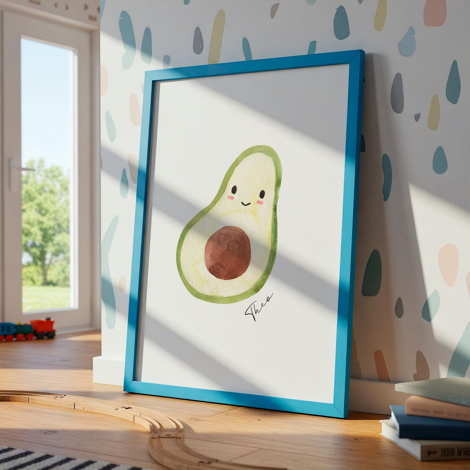 Namensposter Avocado A3 & A4: Ein gerahmtes Aquarell-Print von einer lächelnden Avocado in einem Kinderzimmer, perfekt personalisierbar und langlebig auf Naturpapier gedruckt.